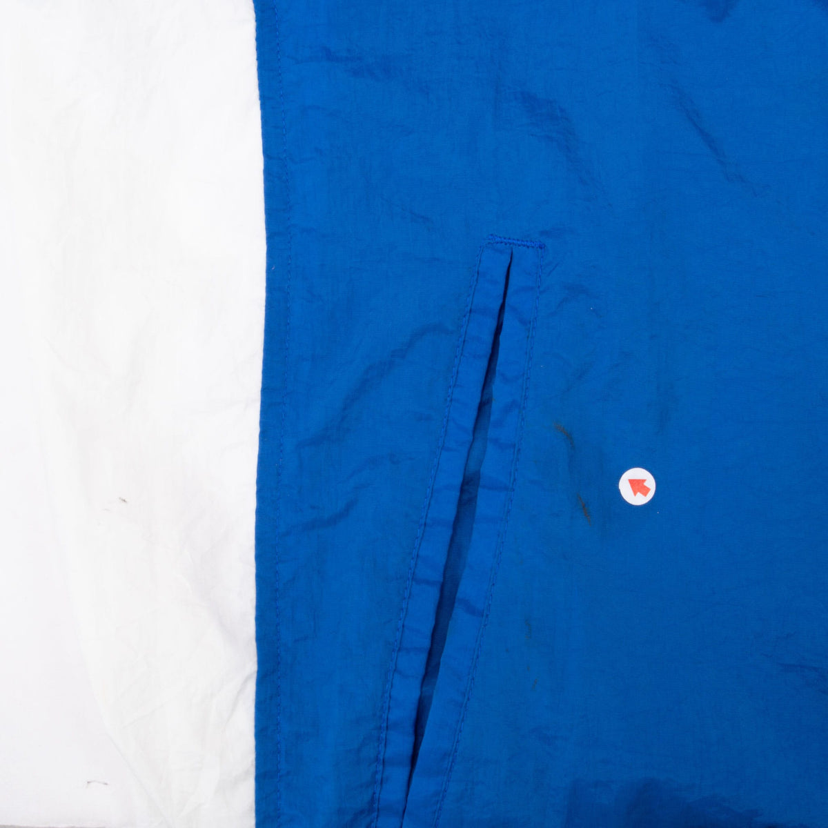 Front pocket detail on blue panel beside white color-block section