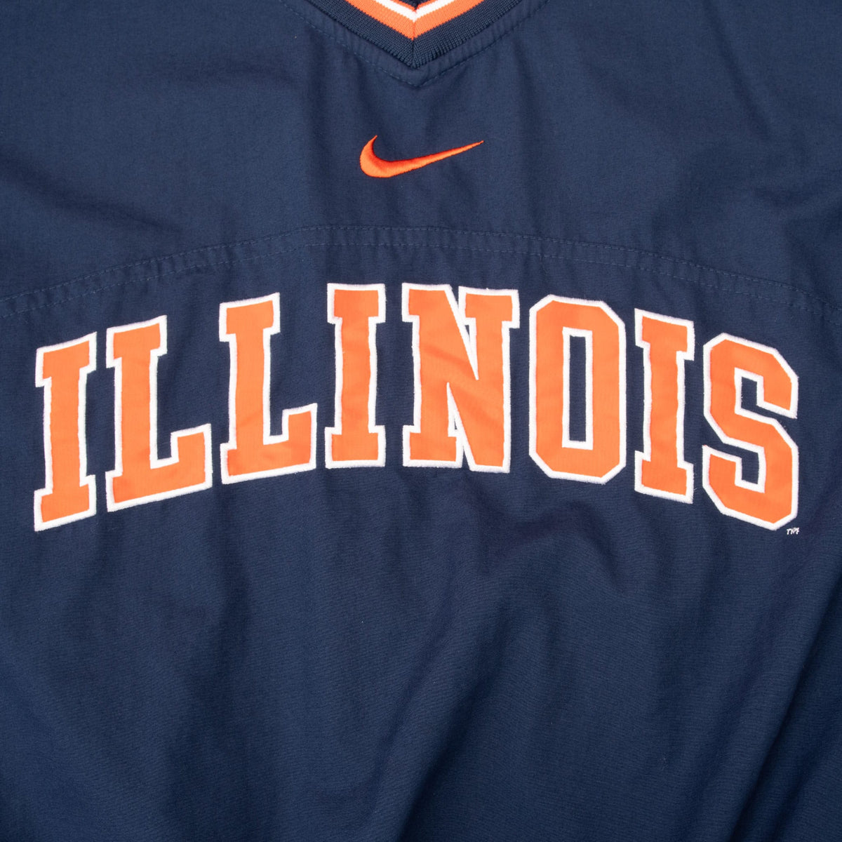 Close-up of orange Nike Swoosh and orange-and-white Illinois front lettering