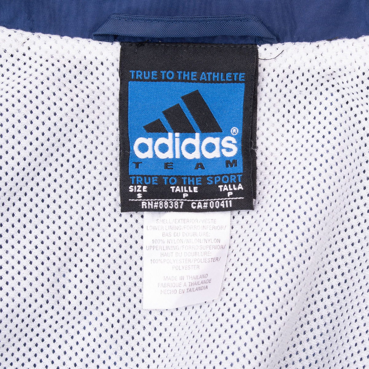 Adidas Team size small neck label against the jacket's white mesh lining