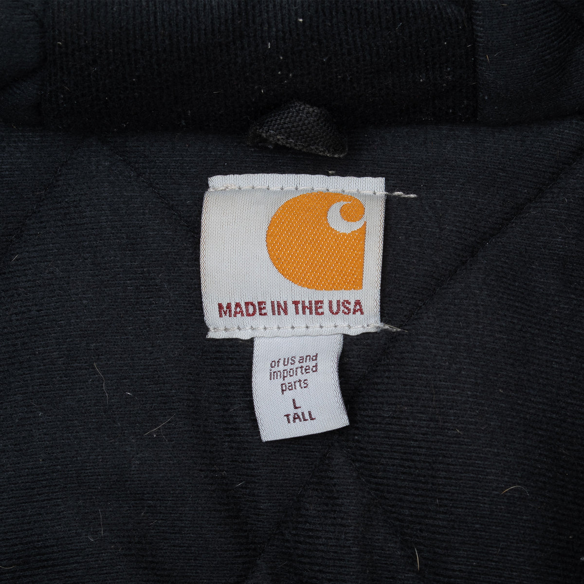 Carhartt jacket neck label reading Made in the USA with Tall tag