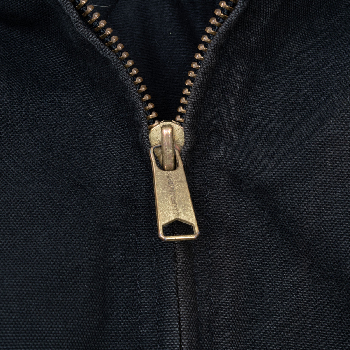 Close-up of metal zipper on black Carhartt active jacket