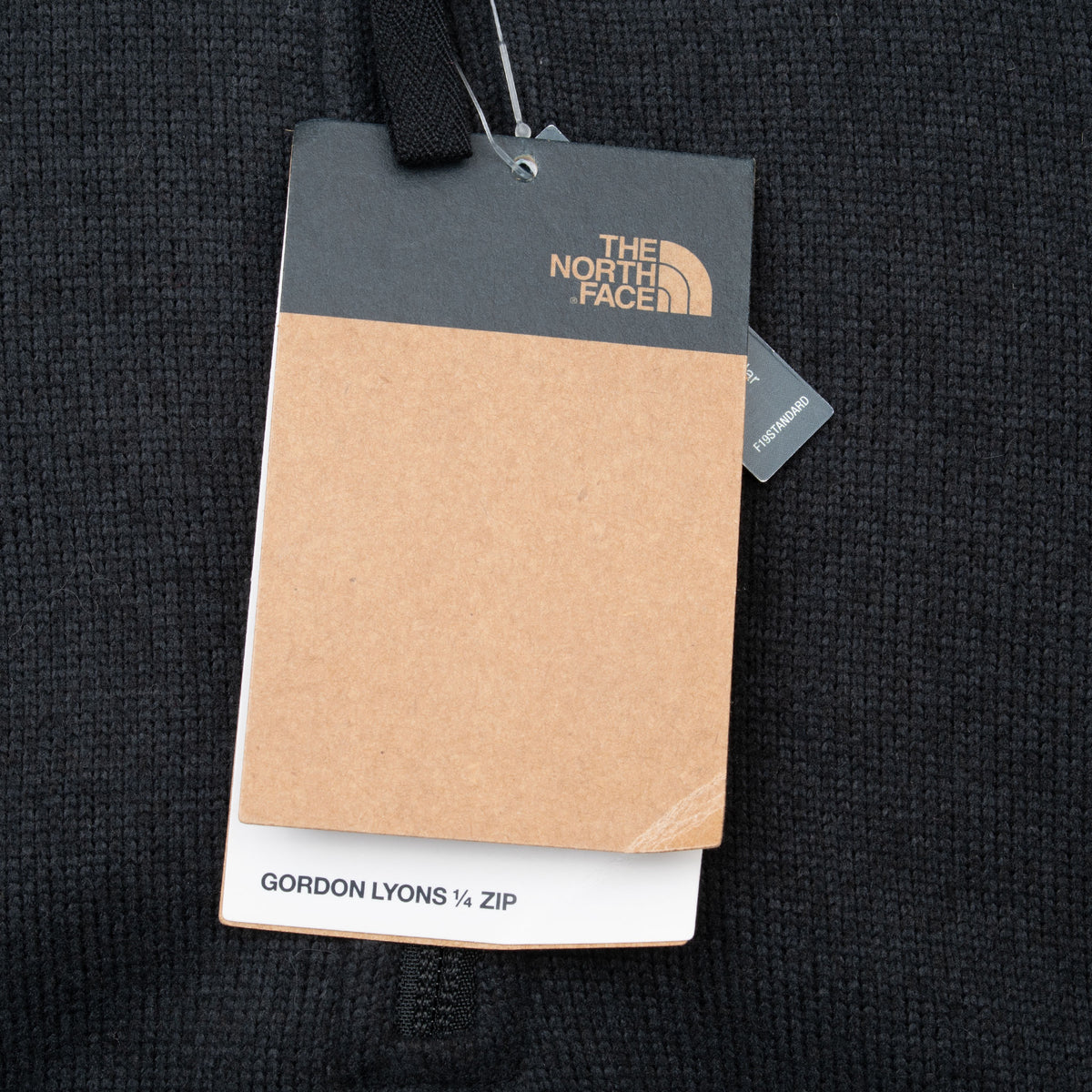 The North Face hangtag labeled Gordon Lyons quarter zip