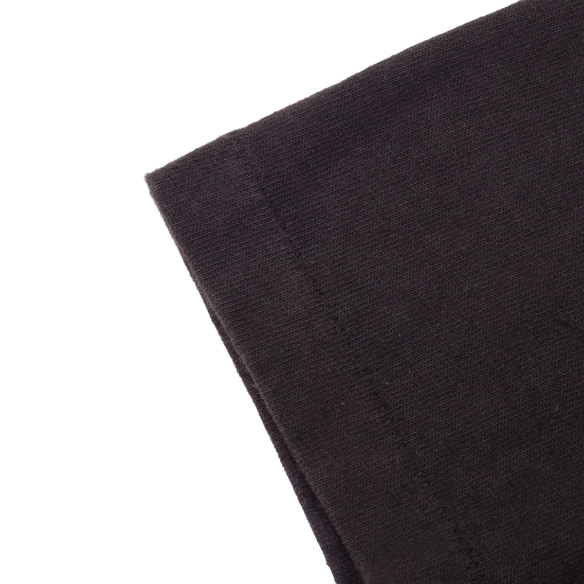 Close-up of black T-shirt sleeve hem and single-stitch seam