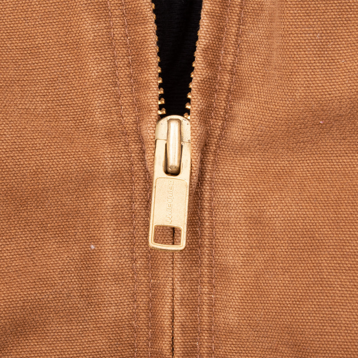 Close-up of metal front zipper on brown Carhartt jacket