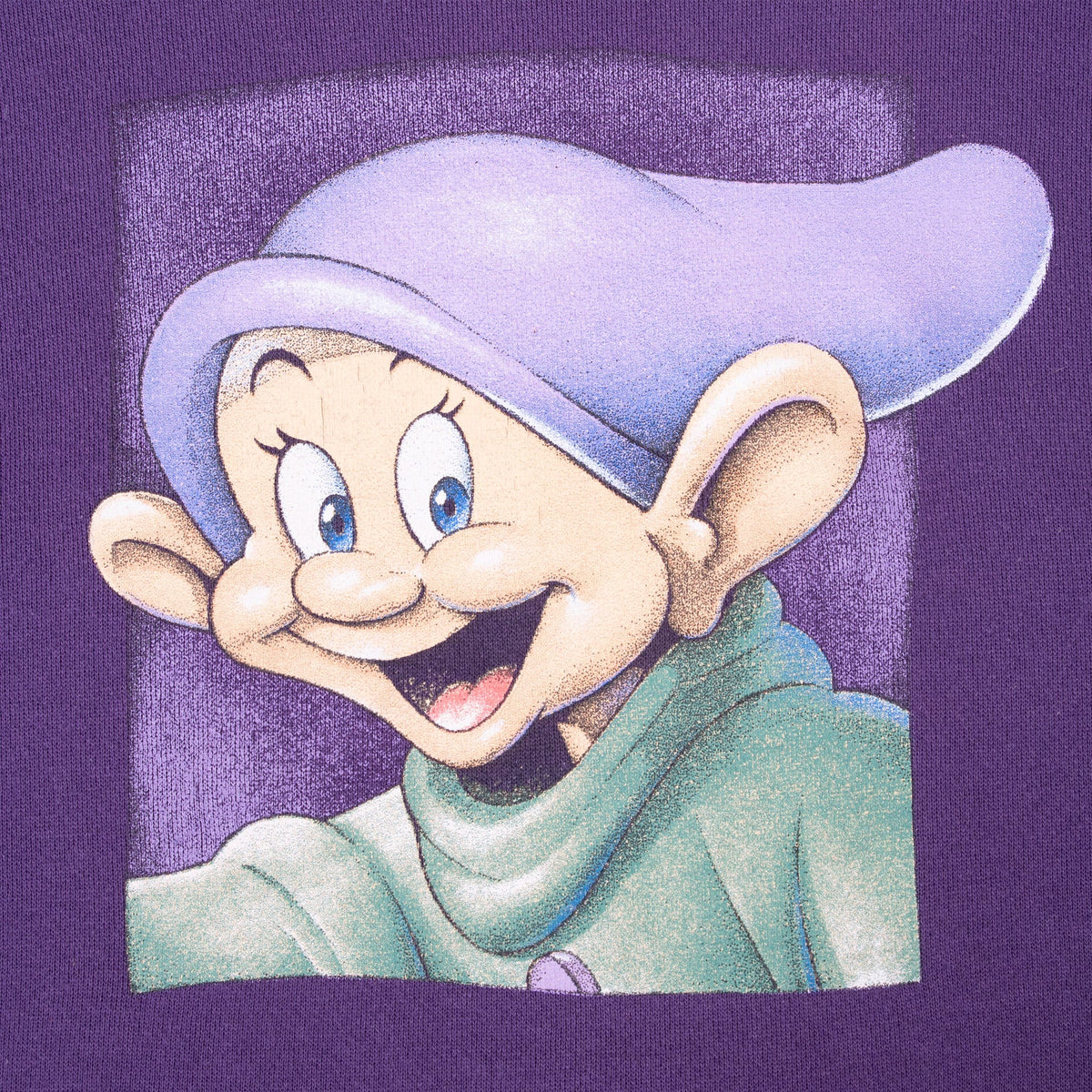 Close-up of colorful Dopey portrait graphic printed on purple sweatshirt