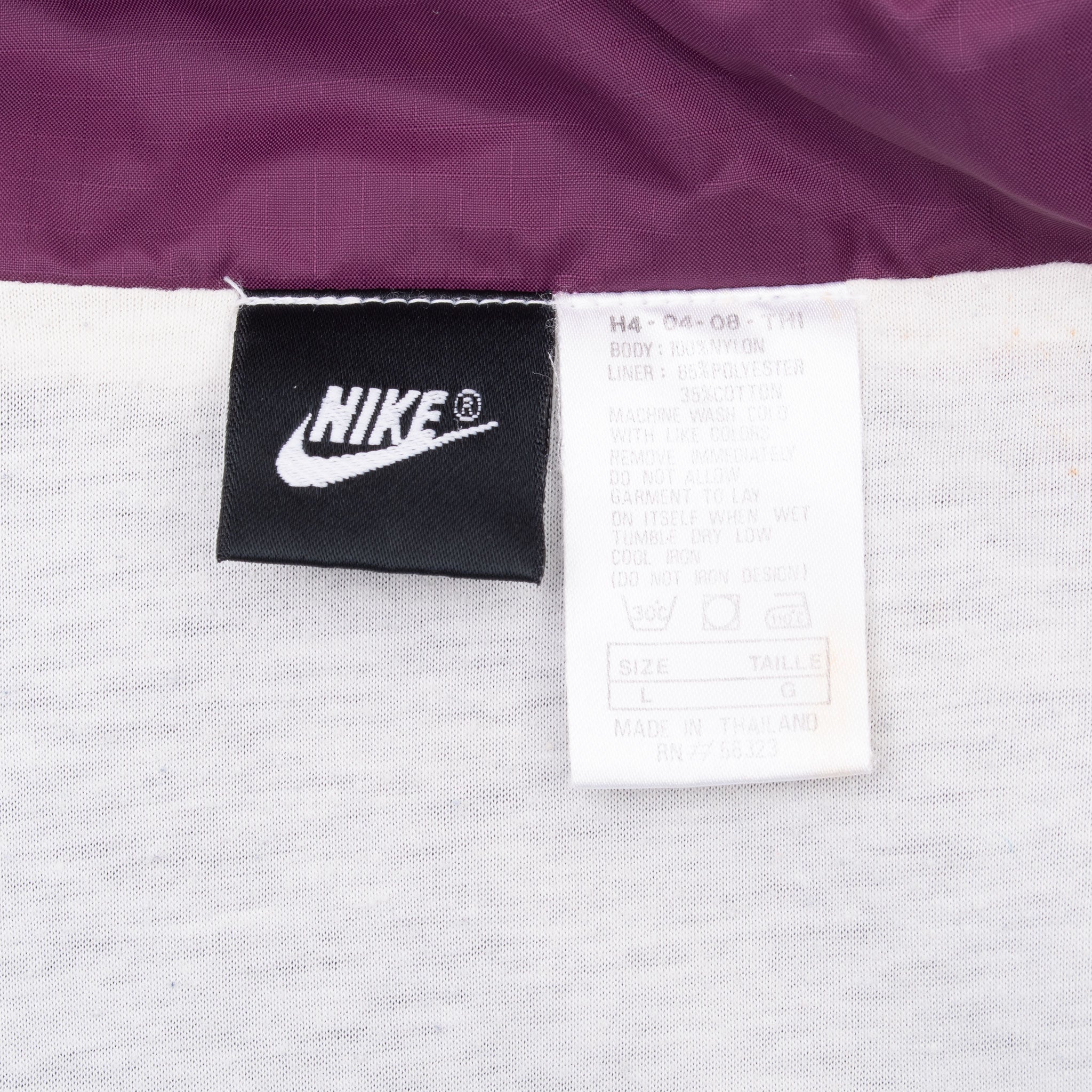 Nike neck and care labels inside windbreaker jacket