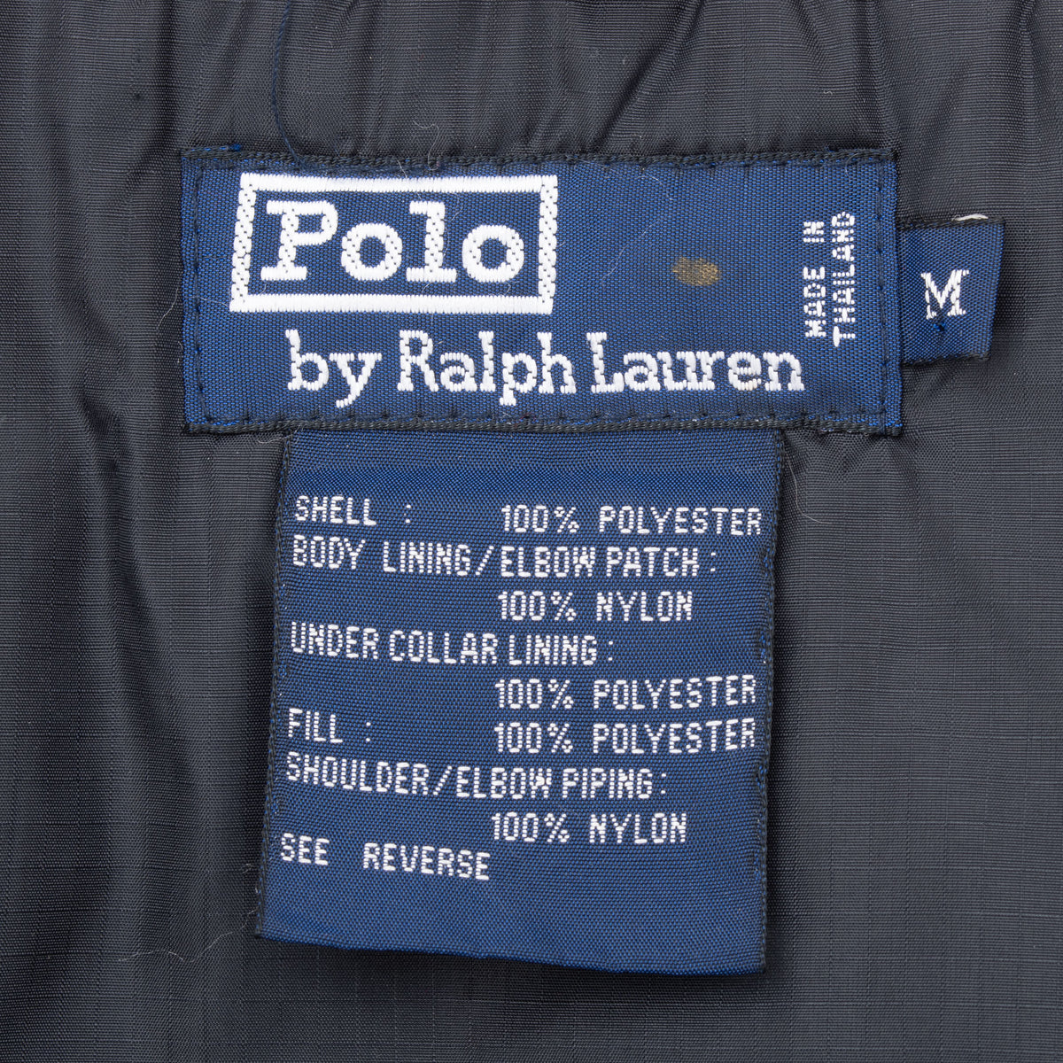 Polo by Ralph Lauren neck and care labels with medium size tag inside ski jacket