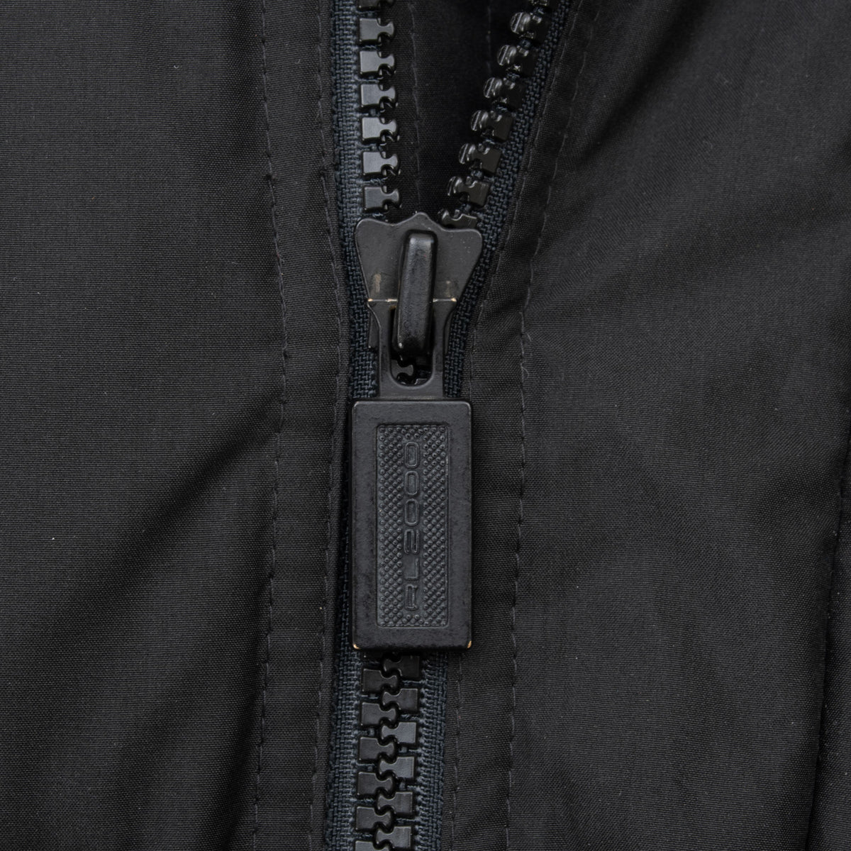 Close-up of black molded zipper and Polo pull on Ralph Lauren Hi Tech ski jacket