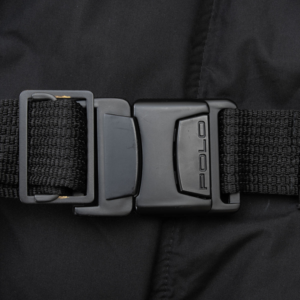 Close-up of black Polo buckle and webbing belt on Ralph Lauren Hi Tech ski jacket