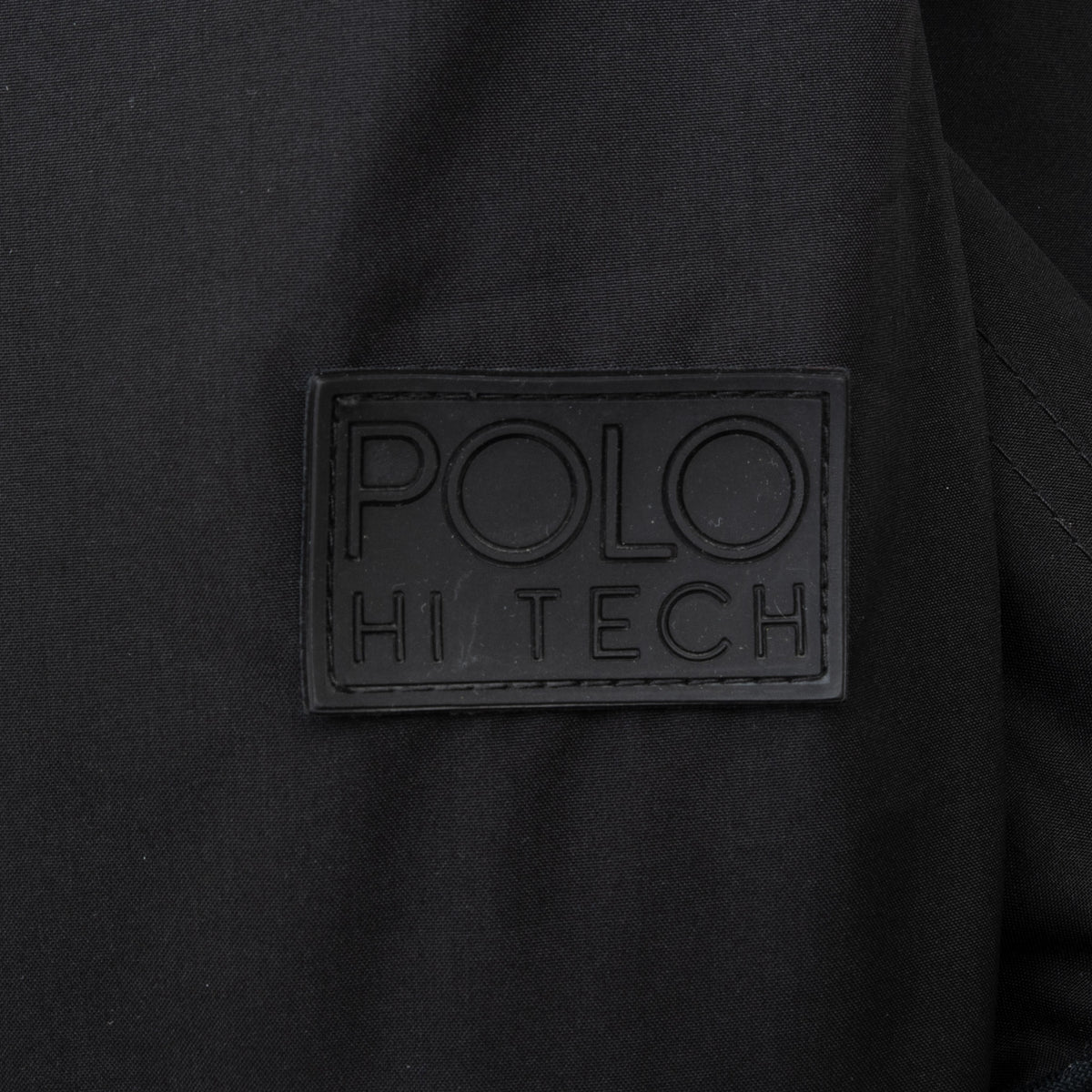 Close-up of black Polo Hi Tech logo patch on ski jacket