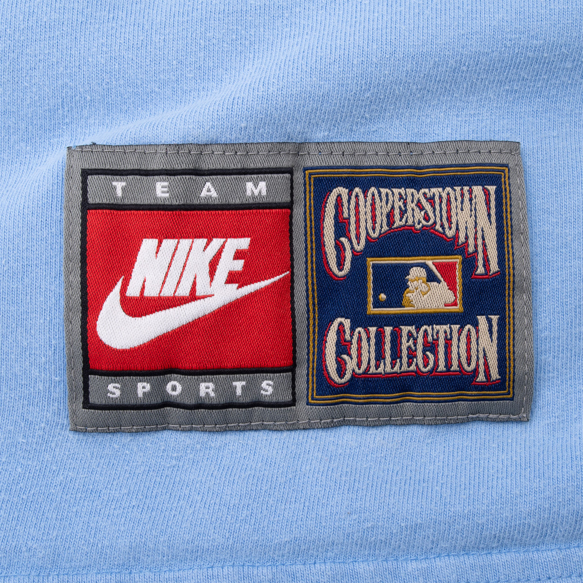Close-up of Nike Team Sports and Cooperstown Collection patch near the front hem