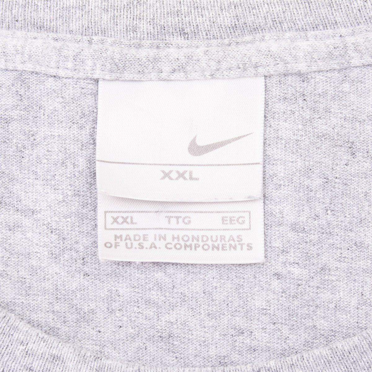 Nike neck tag showing Swoosh logo and XXL size on grey T-shirt
