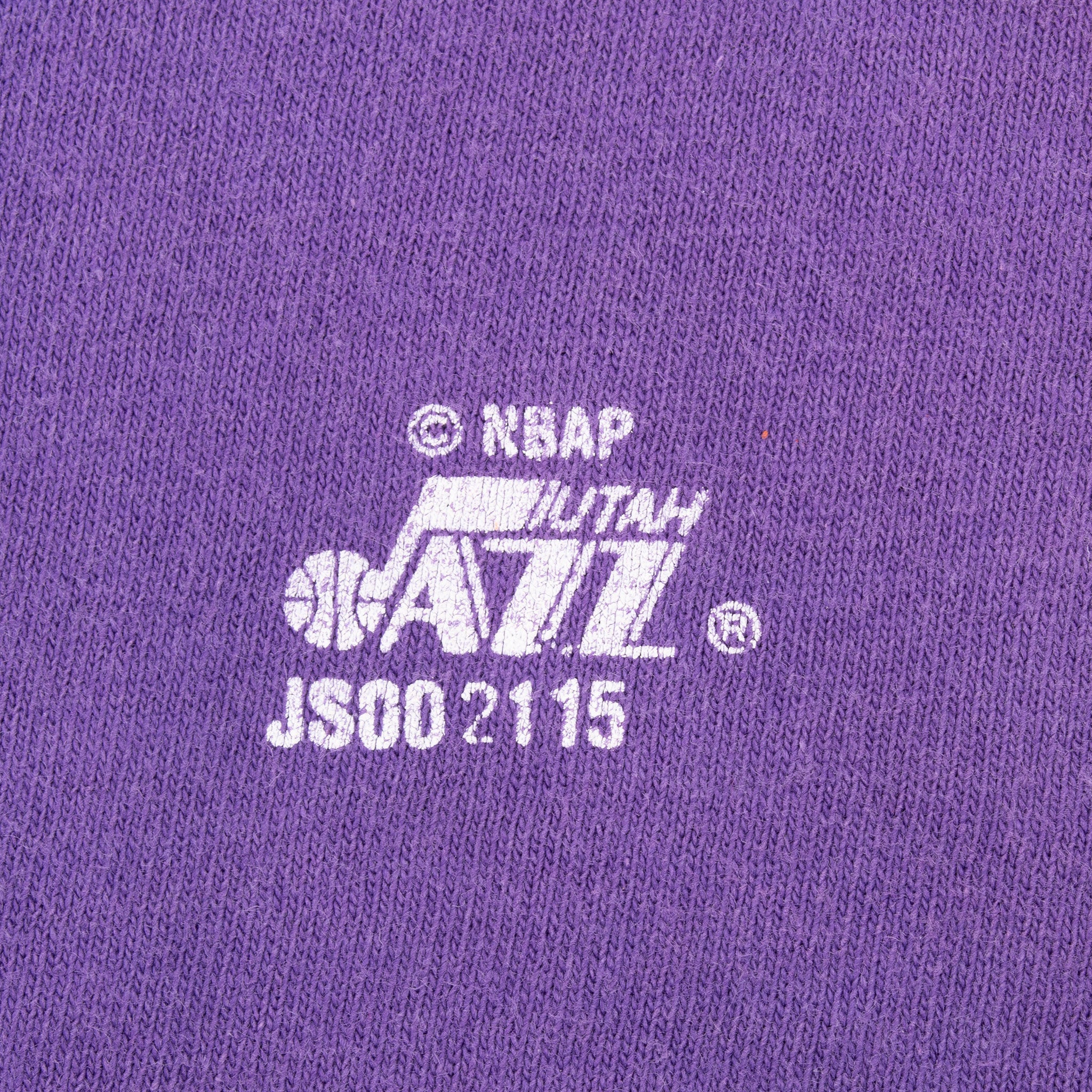 Close-up of Utah Jazz and NBAP licensing print on purple fabric