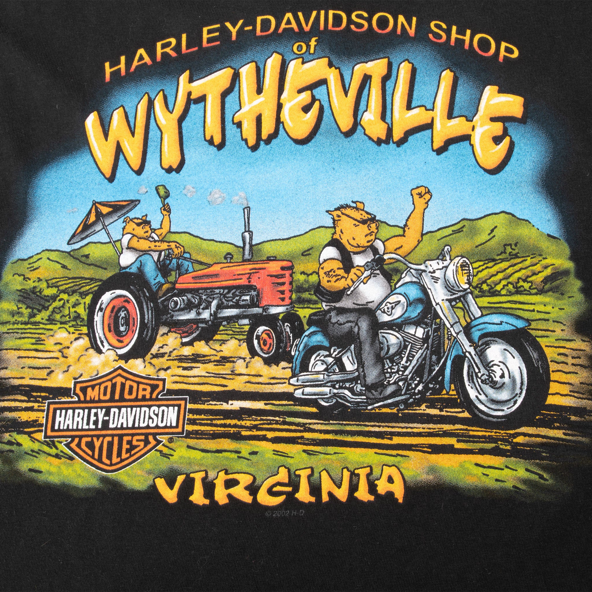 Close-up of Wytheville, Virginia back graphic with rider, motorcycle, tractor, and mountain landscape