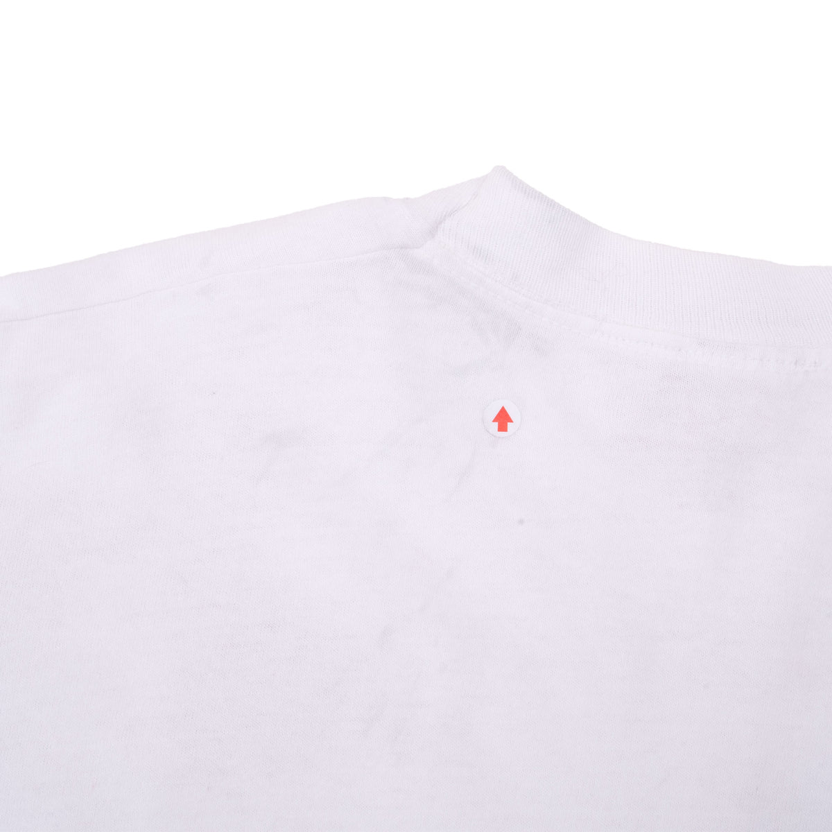 Close-up of upper back fabric with arrow marking a small faint spot