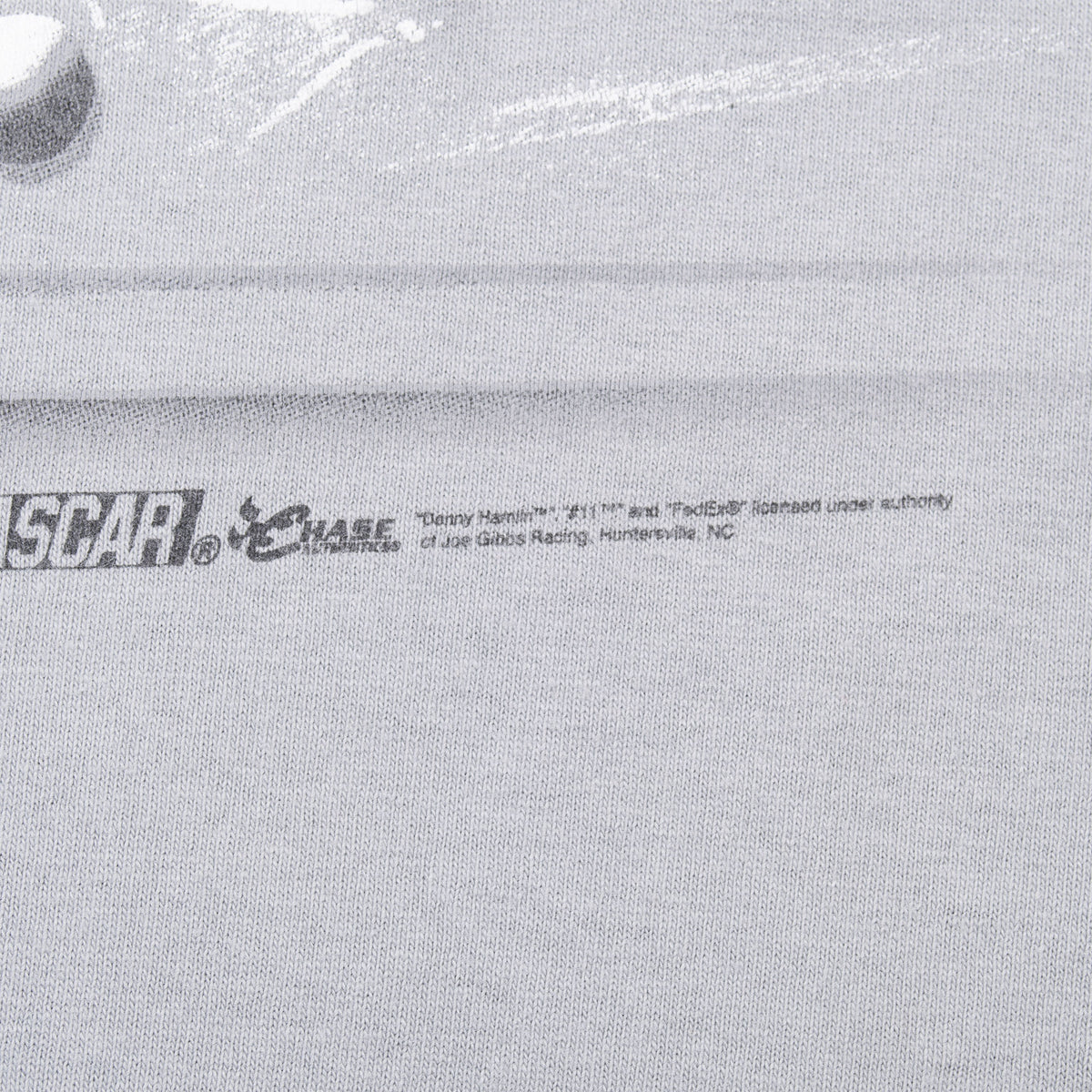 Close-up of NASCAR and Chase licensing print on gray T-shirt fabric
