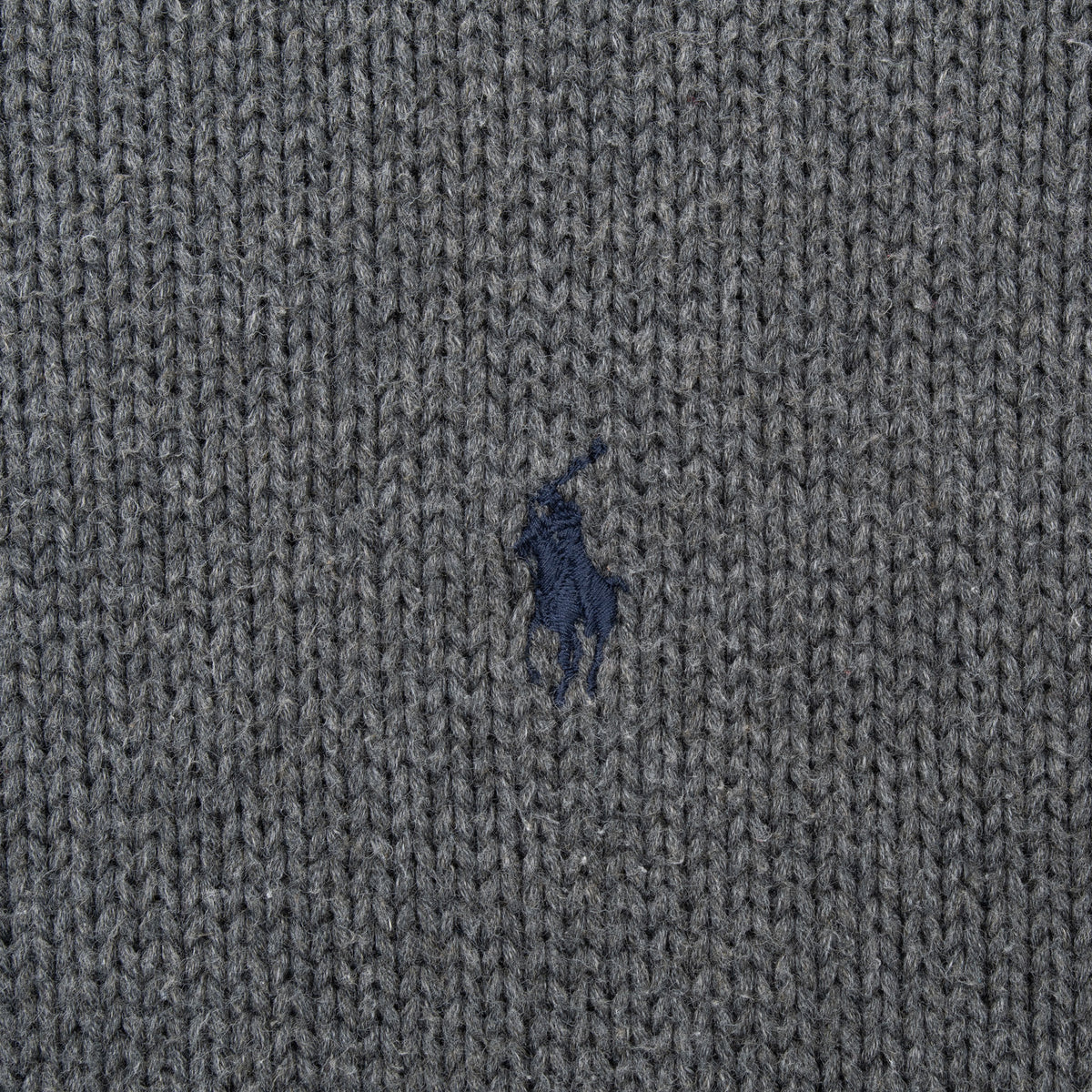 Close-up of navy Ralph Lauren pony embroidery on grey knit fabric