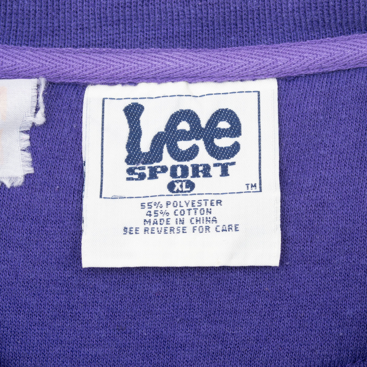 Close-up of Lee Sport XL neck label inside purple sweatshirt