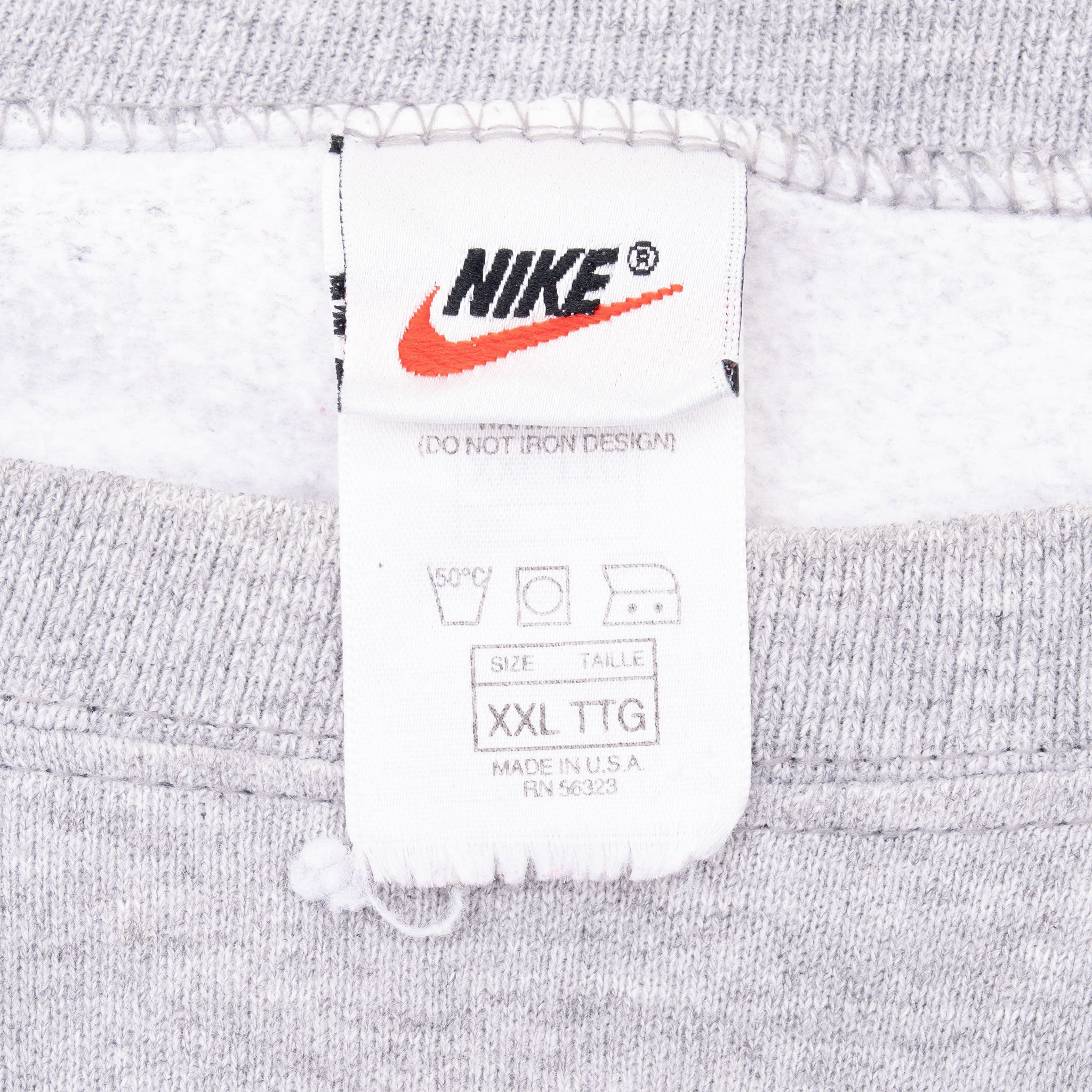 Nike neck tag on grey sweatshirt showing XXL size and Made in USA text