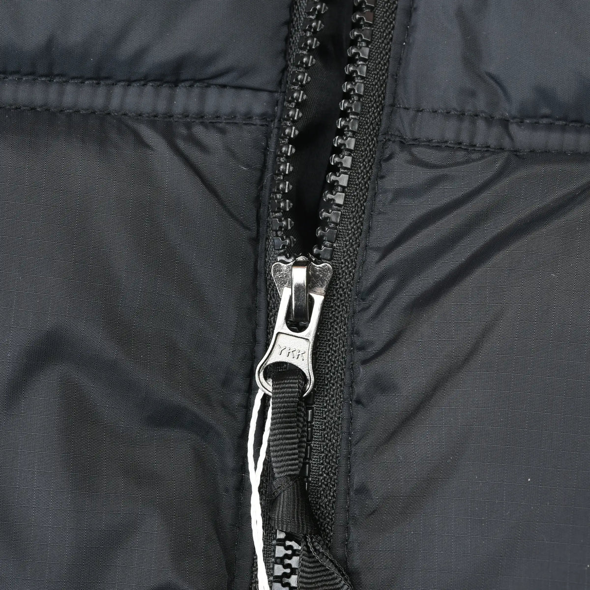 Close-up of front zipper and black shell fabric on The North Face Nuptse jacket