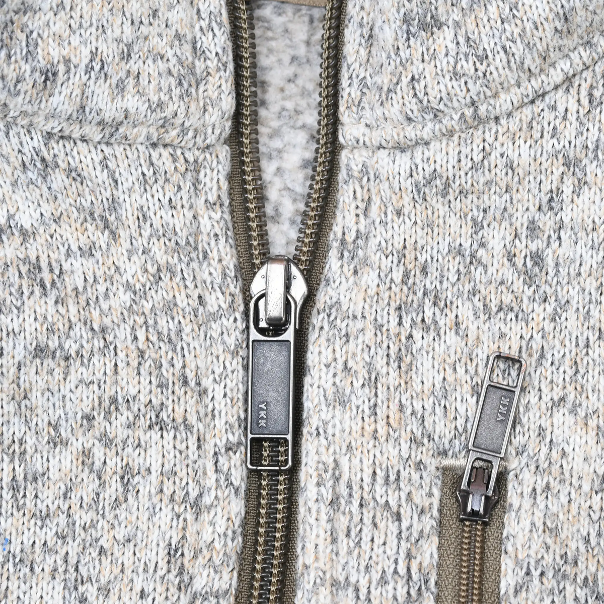 Close-up of quarter-zip and chest pocket zippers on Patagonia fleece