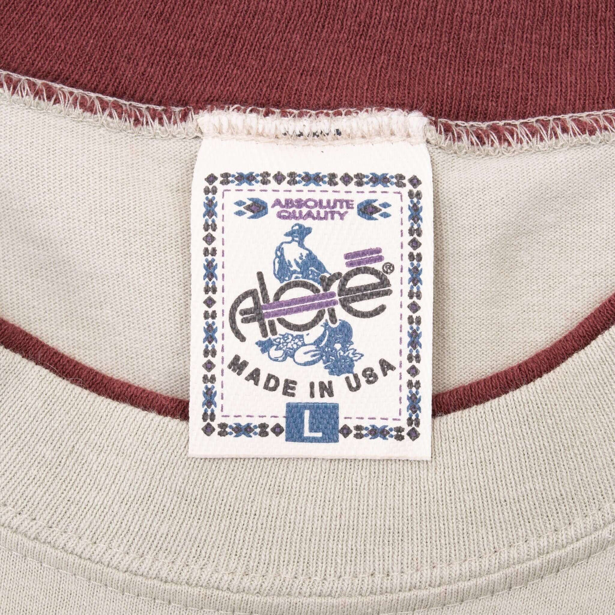 Close-up of Absolute Quality size L Made in USA neck tag and burgundy collar