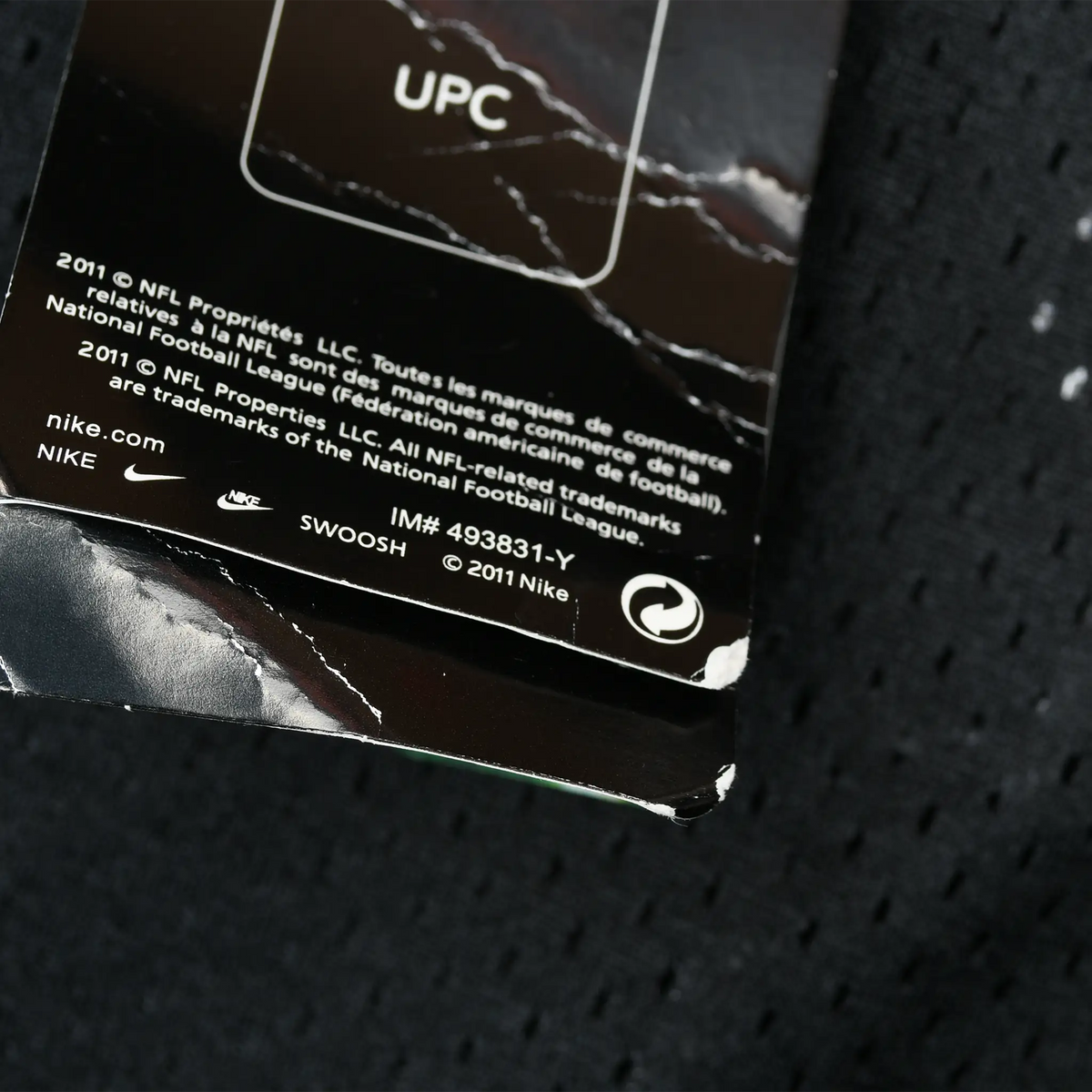 Back of Nike hangtag showing 2011 NFL licensing text and item number 493831-Y