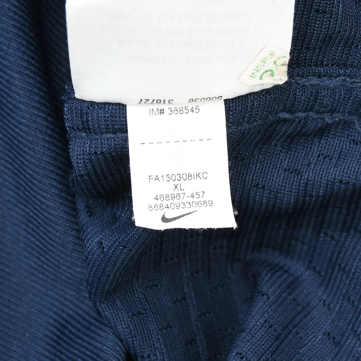 Interior Nike care tag with product codes and XL marking