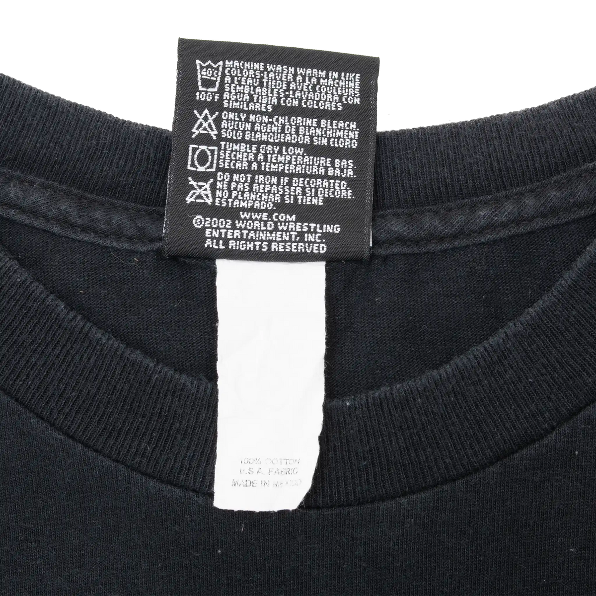 Reverse of WWE T-shirt neck tag showing care instructions and copyright text