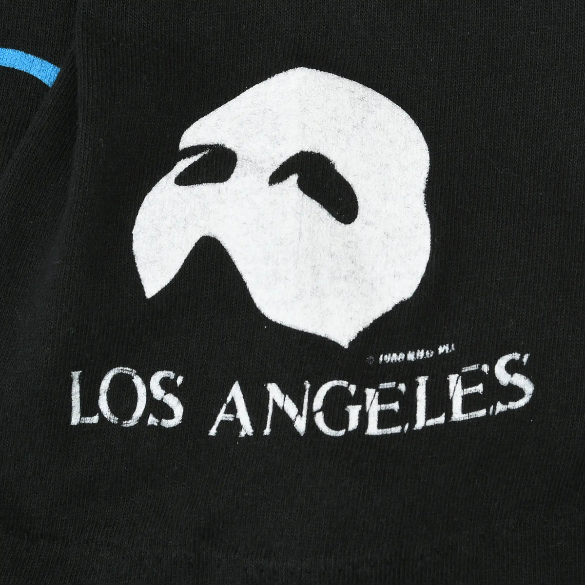 Close-up of white Phantom mask and Los Angeles sleeve print