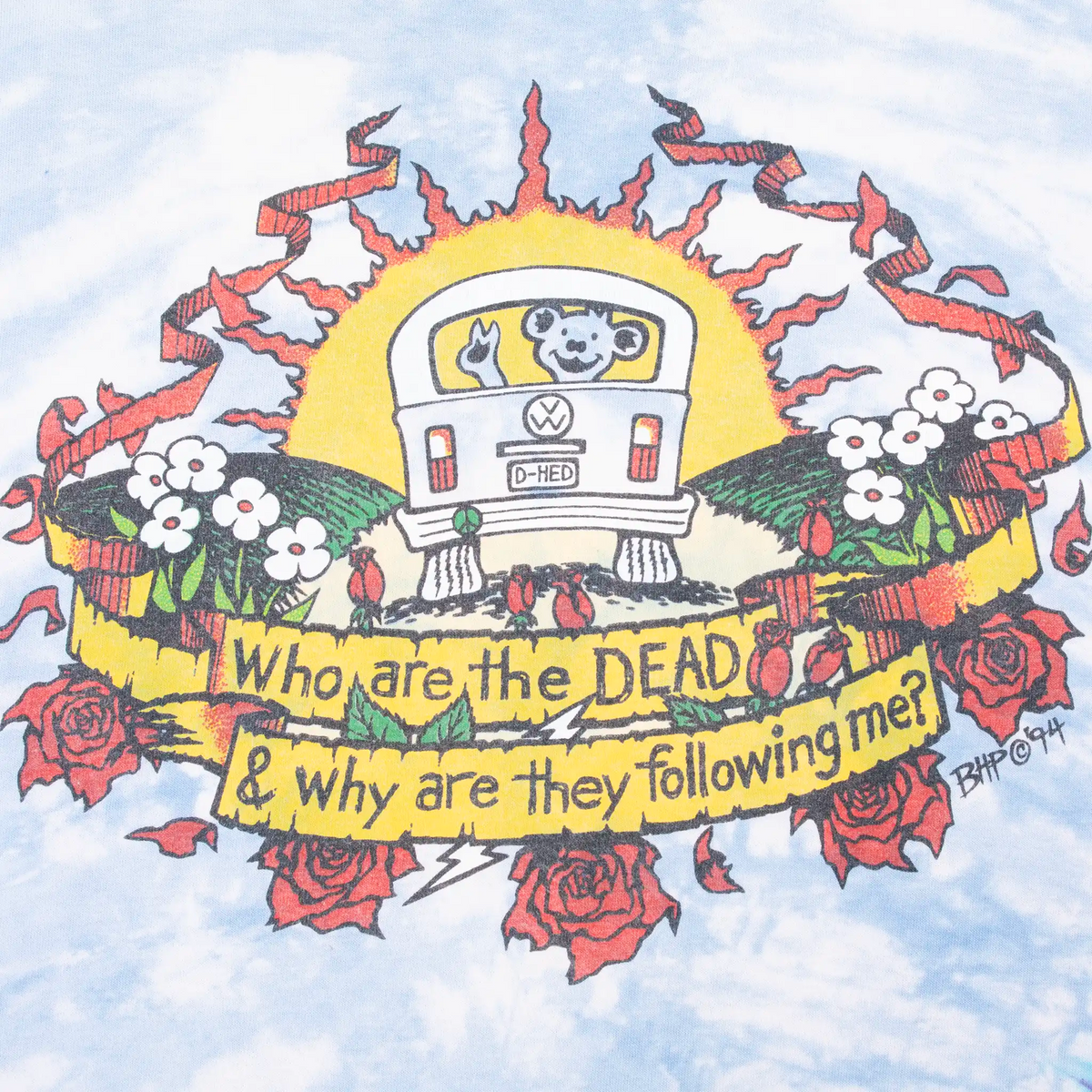 Close-up of back bus and roses graphic reading Who are the DEAD & why are they following me?