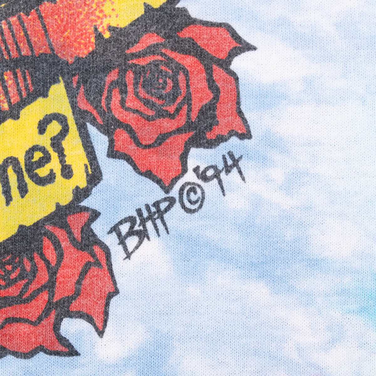 Close-up of red rose and BHP ©94 signature on the back print