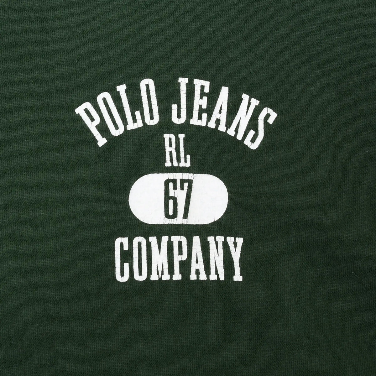 Close-up of white Polo Jeans RL-67 Company chest print on green fabric