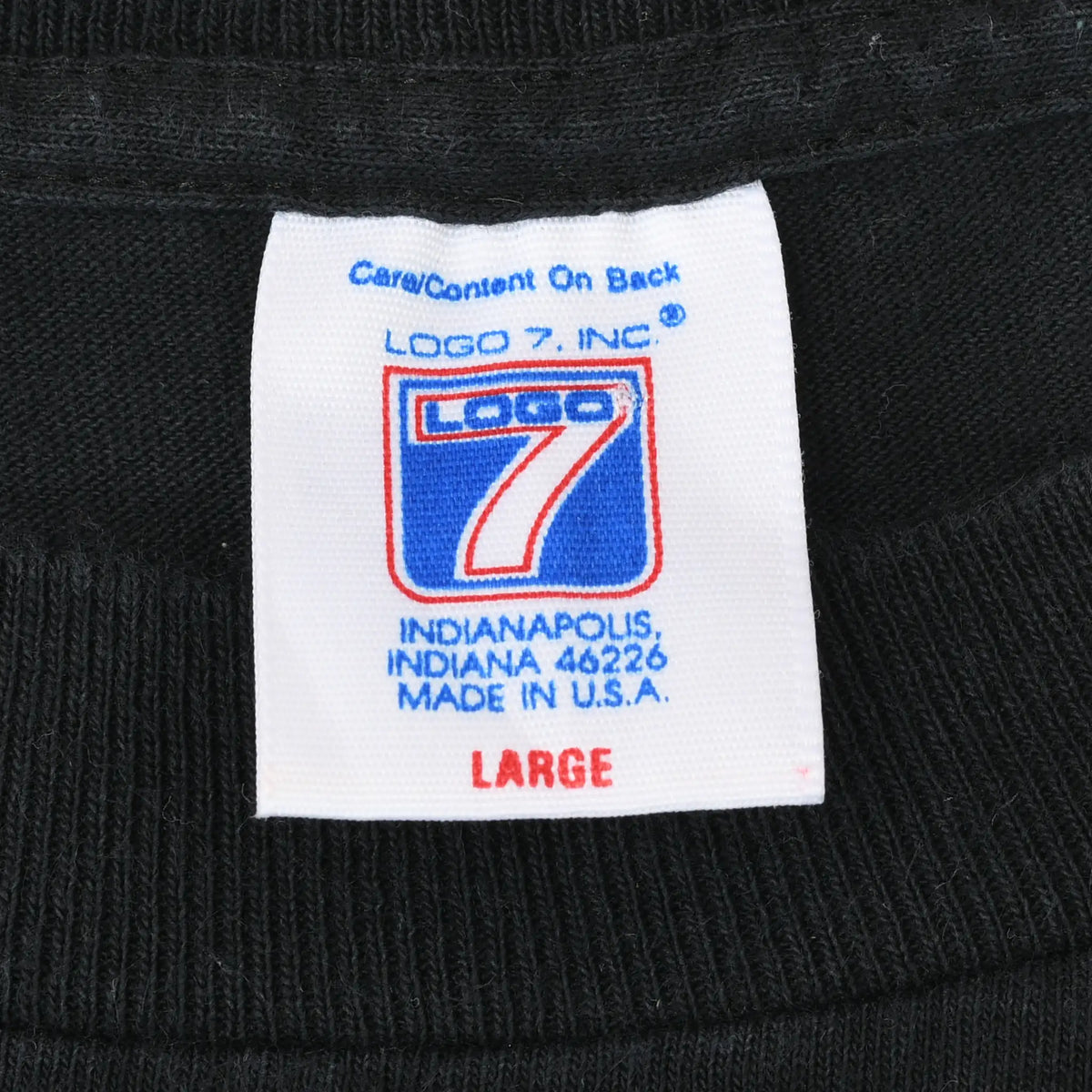 Logo 7 neck tag marked large and made in USA on black T-shirt