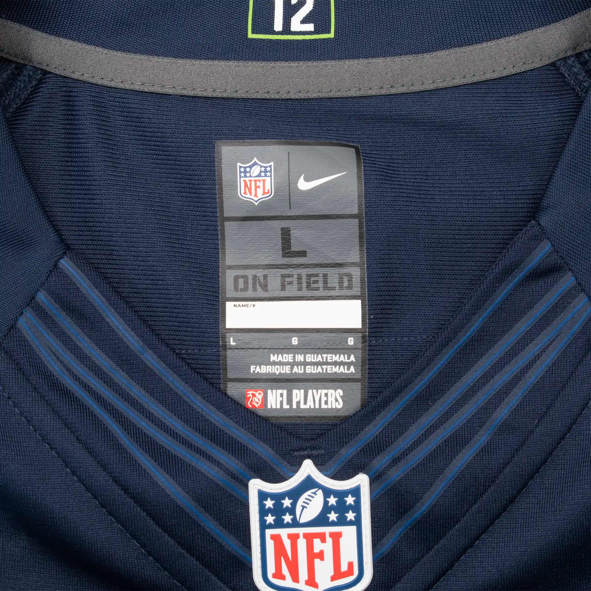 Nike NFL On Field size large neck label and NFL shield on navy jersey