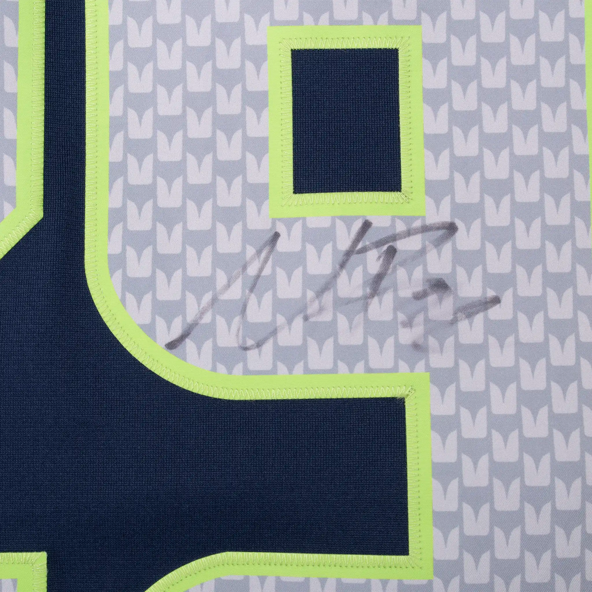 Close-up of signature across the silver and navy front number 29