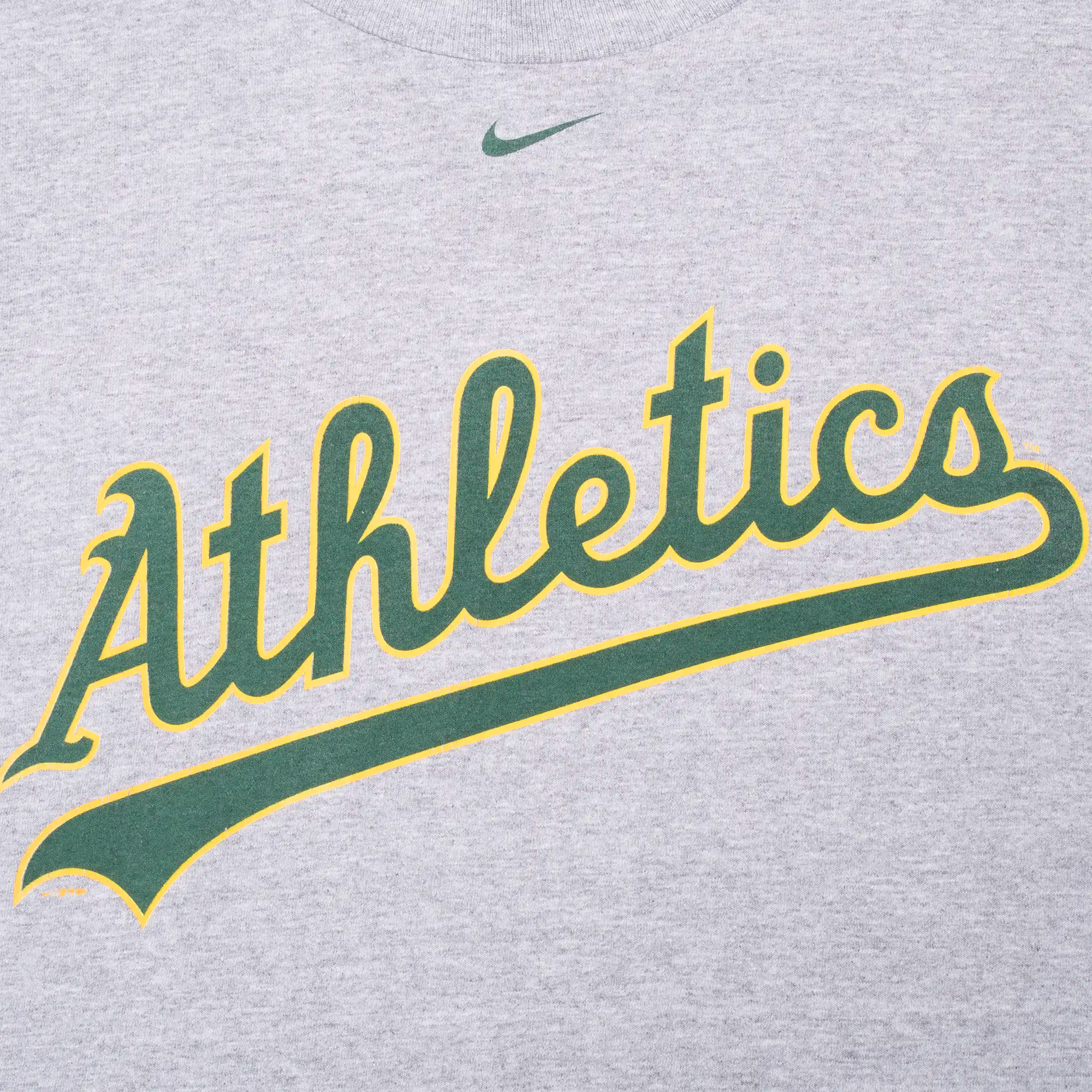 Close-up of green and yellow Athletics chest script and green Nike Swoosh
