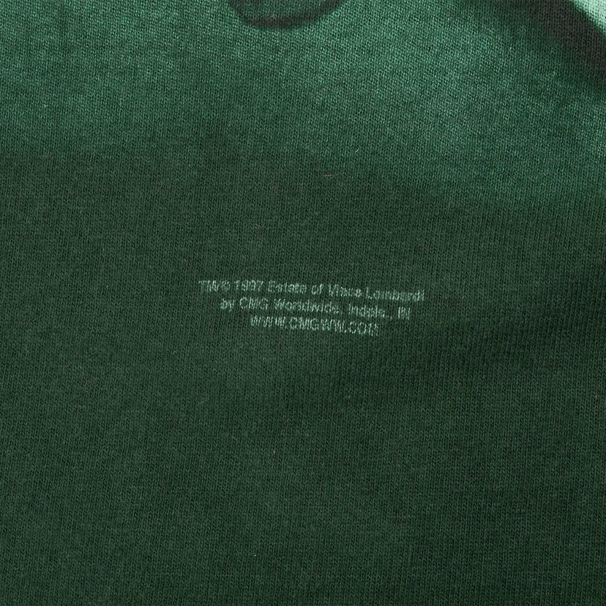 Close-up of faint copyright text printed below the front graphic