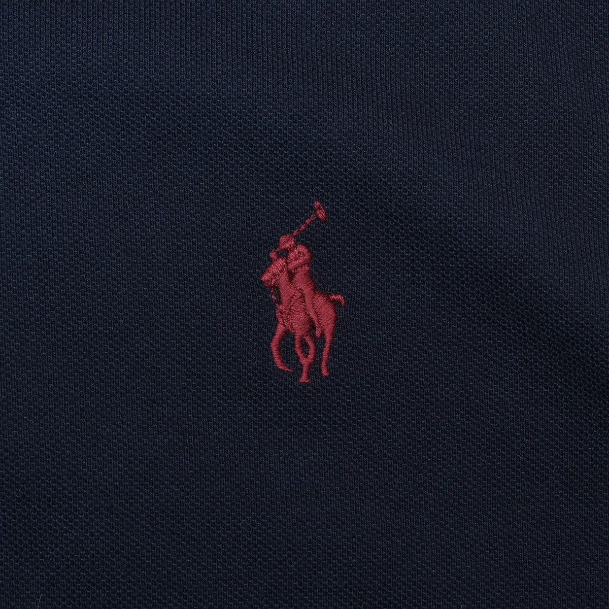 Close-up of red Polo Ralph Lauren pony embroidery on navy fabric