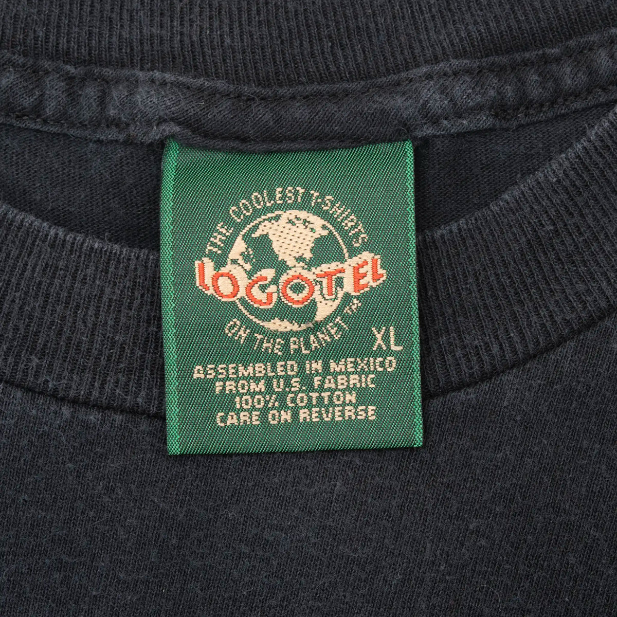 Close-up of green Logotel XL neck tag on black NWO T-shirt