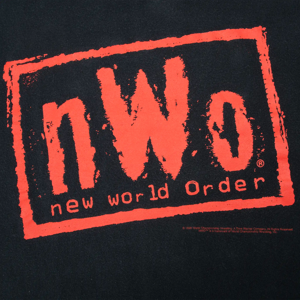 Close-up of red NWO New World Order front graphic on black fabric