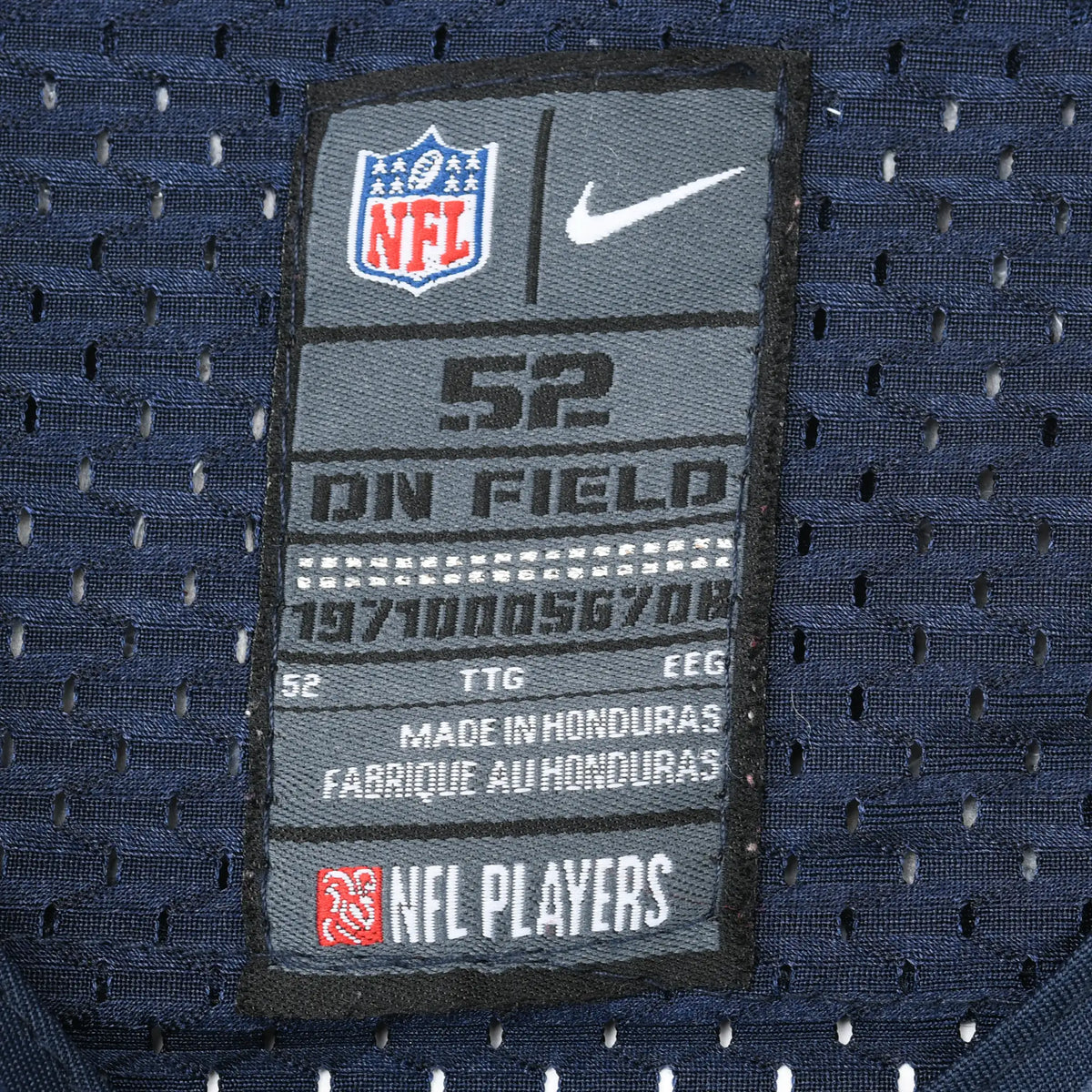 Close-up of Nike NFL On Field size 52 neck label on navy mesh jersey