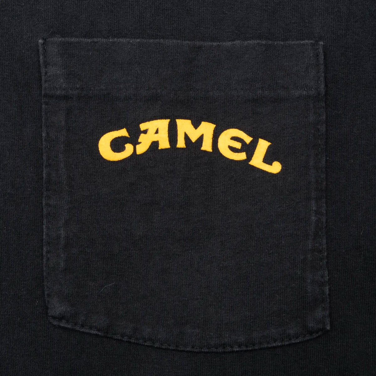 Close-up of chest pocket with yellow Camel logo