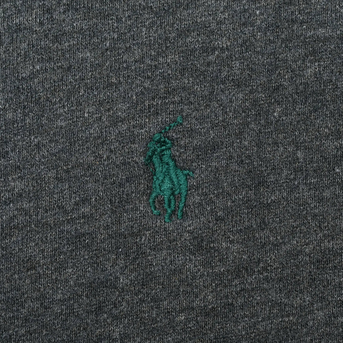 Close-up of green Polo pony embroidery on dark grey sweatshirt