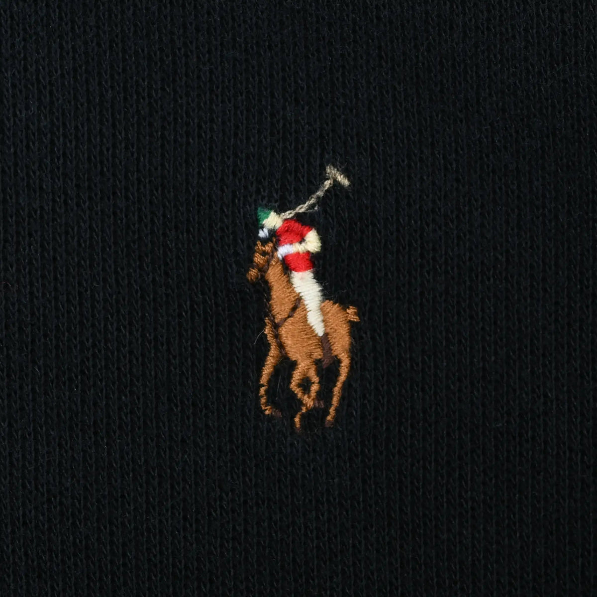 Close-up of multicolor Polo pony embroidery on black sweater