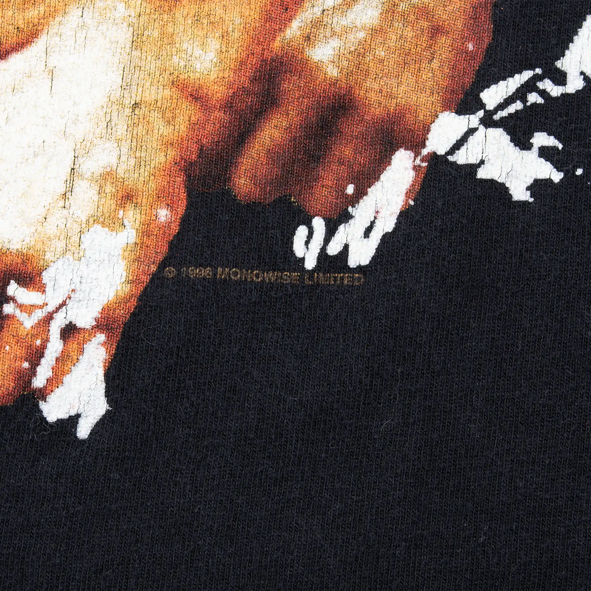 Close-up of copyright text beneath the front graphic on black T-shirt