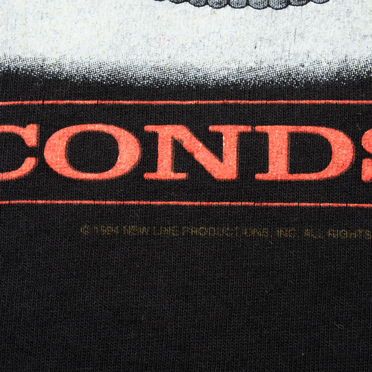 Close-up of red lettering and copyright line on the front print