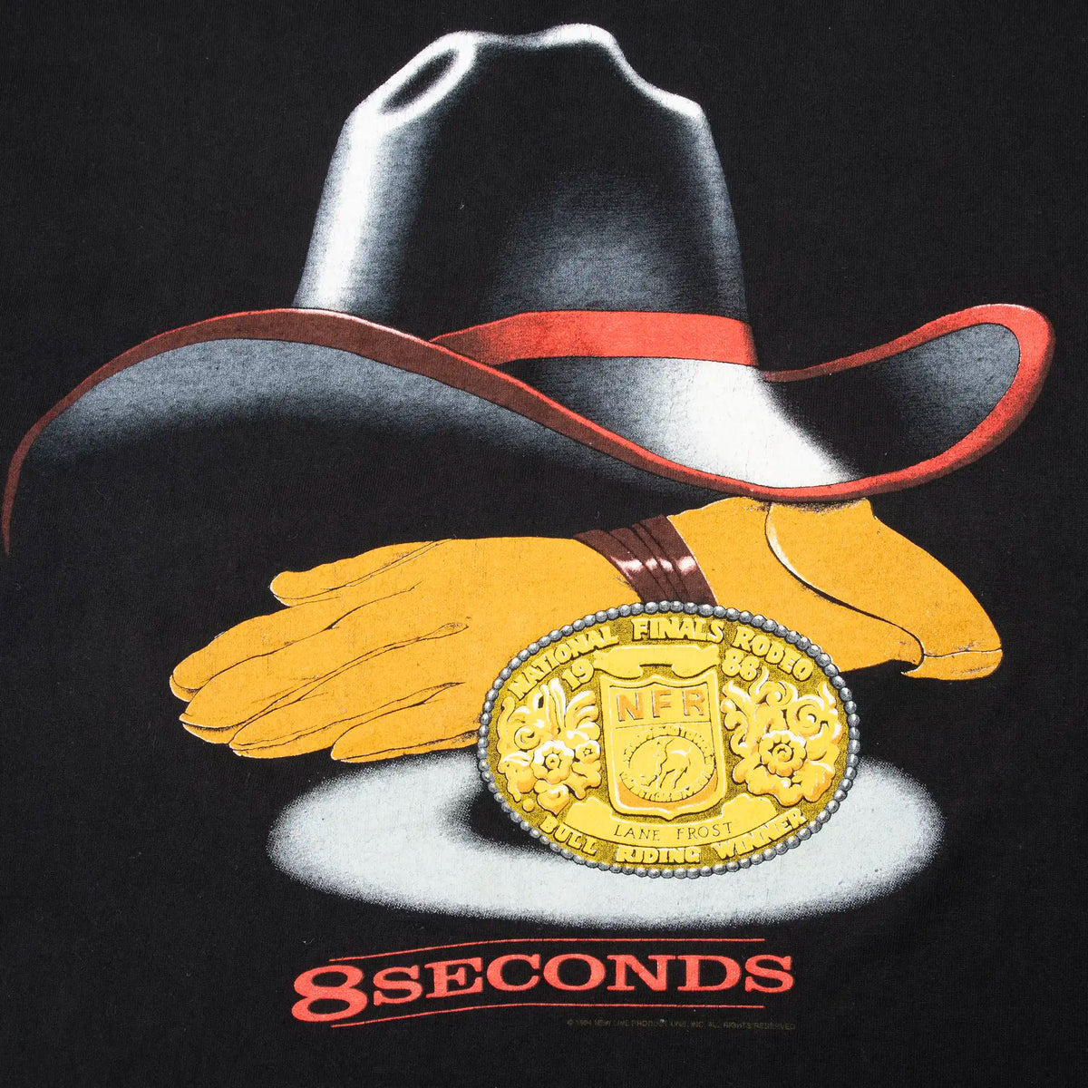 Close-up of cowboy hat, gloves, NFR buckle and 8 Seconds front graphic