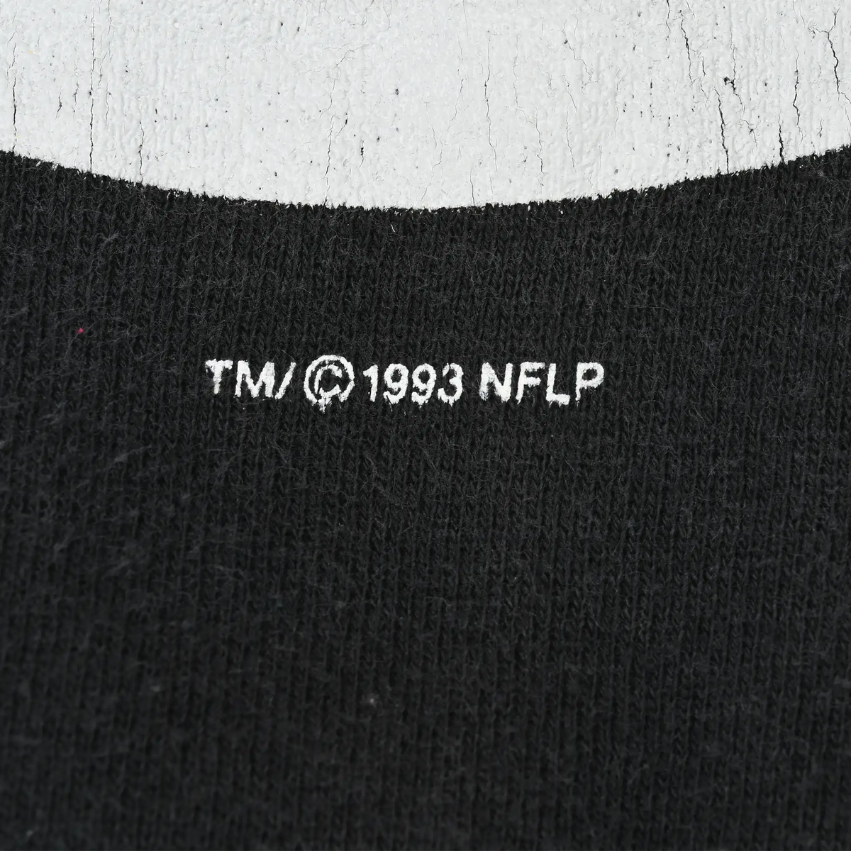 Close-up of 1993 NFLP trademark print beneath the Steelers graphic