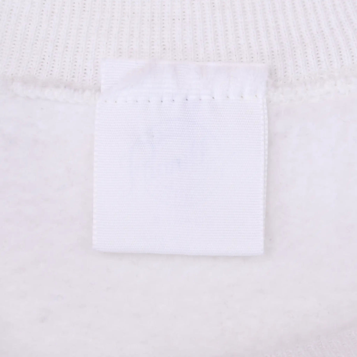 Close-up of blank white sweatshirt neck tag and collar stitching
